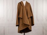 Le manteau est marron et est muni d'une capuche.