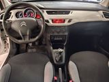 the interior of a small car with a steering wheel and dashboard
