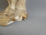 a statue of a horse that is standing on a rock