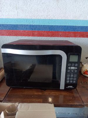 a microwave sitting on a table with a box on it
