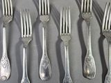 a lot of forks and spoons that are on a table
