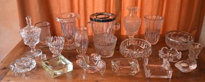 a lot of glass items sitting on a wooden table