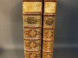 a pair of old books sitting on top of each other