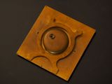 an image of a brass plate with a hole in the middle