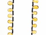 yellow glass beaded necklace with black beads and a silver clasp