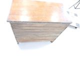 a small wooden chest sitting on top of a white floor