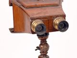 an old wooden camera on a stand on a white background