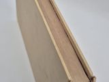 an open book sitting on top of a table next to a white table