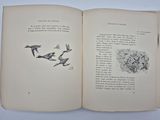 an open book with a drawing of birds flying in the air
