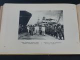 an old photo of a group of men standing in front of a ship
