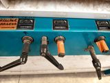 a blue and black machine with orange handles on it