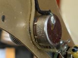 a close up of a sewing machine with a yellow handle
