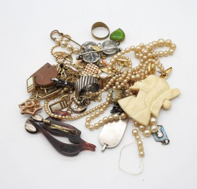 a pile of assorted jewelry on a white surface