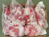 a box full of red and white string wrapped in plastic