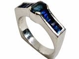 an image of a silver ring with a blue stone in the center