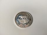 a close up of a silver coin with a cat on it