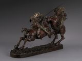 statue of a man on a horse with a spear riding a horse