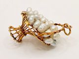 gold plated brooch with white pearls on a white background