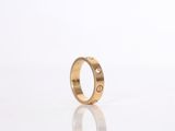 a close up of a gold ring on a white surface