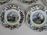 four plates with a picture of a soldier on them on a table