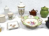 many different types of teapots and cups on the table