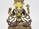 a bronze figure of a buddha with a snake in his hands