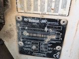 a sign on the side of a machine that says bobcat