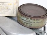a knife and a tin of wax sitting on a table