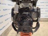 the engine of a car is sitting on top of an orange stand