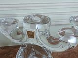 a glass candle holder on a marble counter top