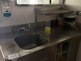 a kitchen with a sink and a refrigerator in it