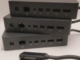 three pieces of black electrical equipment sitting on top of a white surface
