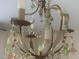 a chandelier that has a bunch of glass beads hanging from it