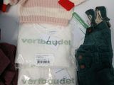 a pile of clothes and a sweater sitting on a table