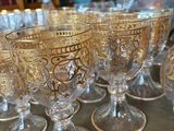 a lot of glasses sitting on a table in a room