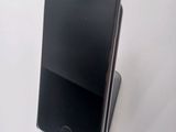 the iphone is sitting on top of the stand on the table