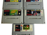 Quatre cartouches de jeux Nintendo sont empilées les unes sur les autres