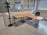a desk with a chair and a lamp in a room