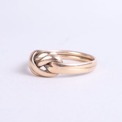 an image of a gold ring with a knot in the middle