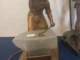 a statue of a man with a hammer on a table