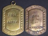 two gold medals with the names of two people on them