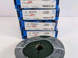 a stack of four rolls of wire with a green spool on top of them
