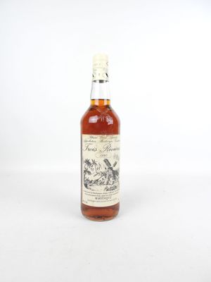 un gros plan d'une bouteille de whisky posée sur une surface blanche