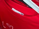 a red shirt that has a white hanger on it