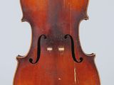 an old violin on a stand against a white background