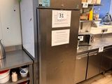 a large stainless steel refrigerator in a kitchen with a lot of counter space