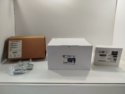 a white box sitting on top of a white table next to a box