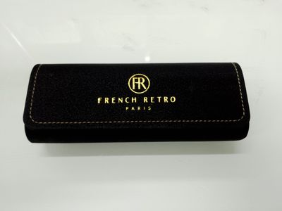a black leather case with a gold logo on it