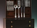 an image of a set of silverware in a wooden box