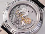a close up of a watch with a black leather strap